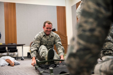 U.S. Air Force Airman 1st Class Dakoda Wholly, an aerospace medical technician assigned to the 673d Medical Operation Squadron, opens a litter during a Tactical Combat Casualty Care course at Joint Base Elmendorf-Richardson, Alaska, July 12, 2018. The course is designed to provide efficient care during combat by teaching life-saving techniques.