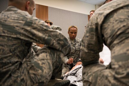 U.S. Air Force Master Sgt. Demetris Johnson, a multi-service unit flight chief assigned to the 673d Inpatient Operations Squadron, instructs 673d Medical Group personnel to perform a needle decompression for a tension pneumothorax during a Tactical Combat Casualty Care course at Joint Base Elmendorf-Richardson, Alaska, July 12, 2018. This procedure is required when air gets into the chest cavity preventing the lung from expanding. The needle releases air, letting the lung expand and the patient breathe again.
