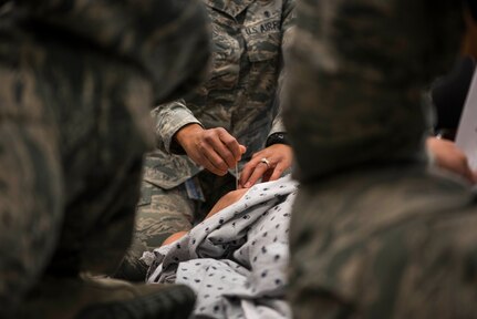 U.S. Air Force Master Sgt. Demetris Johnson, a multi-service unit flight chief assigned to the 673d Inpatient Operations Squadron, instructs 673d Medical Group personnel to perform a needle decompression for a tension pneumothorax during a Tactical Combat Casualty Care course at Joint Base Elmendorf-Richardson, Alaska, July 12, 2018. This procedure is required when air gets into the chest cavity preventing the lung from expanding. The needle releases air, letting the lung expand and the patient breathe again.