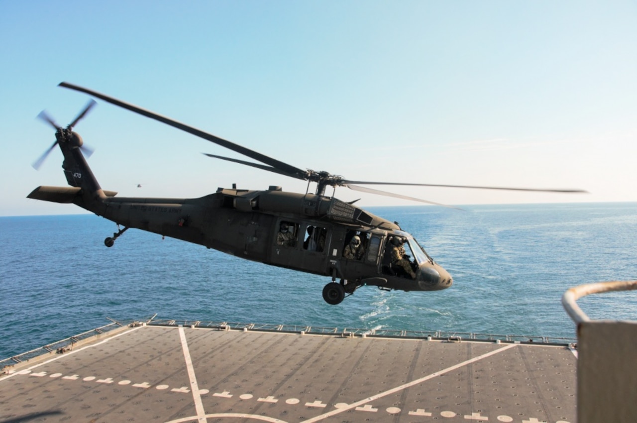 A UH-60 Black Hawk helicopter takes off after landing on the deck of the U.S. Navy Ship Alan Shepard in the Persian Gulf, Dec. 31, 2015.