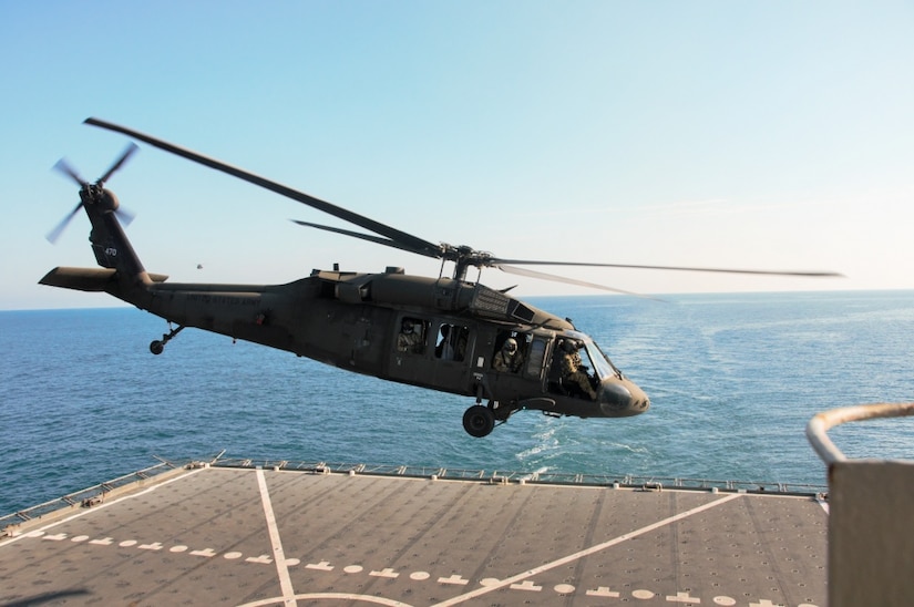 A UH-60 Black Hawk helicopter takes off after landing on the deck of the U.S. Navy Ship Alan Shepard in the Persian Gulf, Dec. 31, 2015.