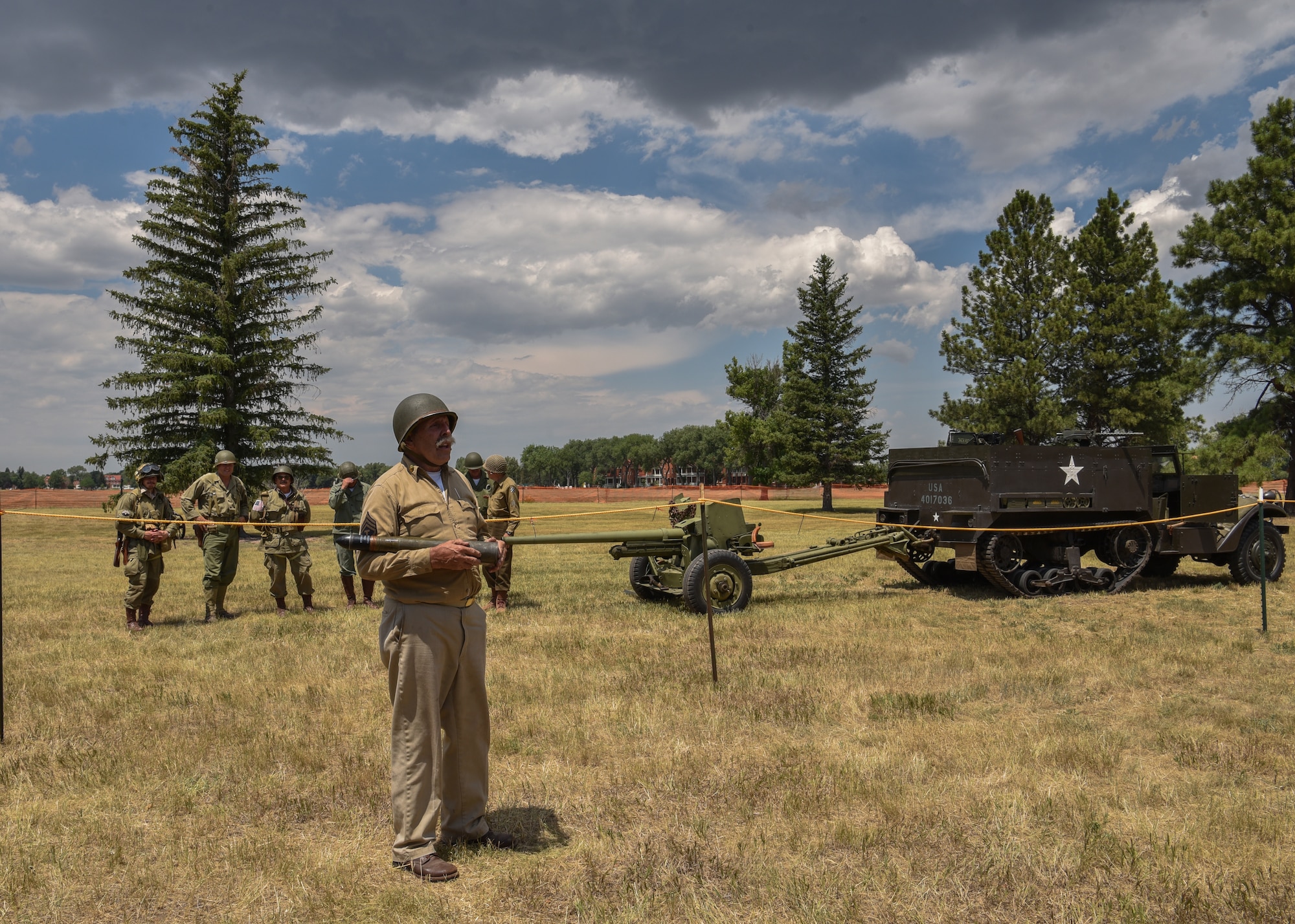 Norman Hughes a World War II re-enactor talks about the ammunition the anti-tank gun uses, during Fort D. A. Russell days on F.E. Warren Air Force Base, Wyo., July 21, 2018. From 1930 to 1949, the base was used as an infantry and artillery training post. The annual open house brings military and civilian communities together to learn more about the base's rich history. (U.S. Air Force photo by Airman 1st Class Braydon Williams)