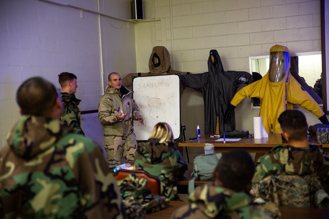 Cpl. Tyler J. Beard, center-left, instructs Marines on the sampling and testing of chemicals during a reconnaissance, surveillance and decontamination (RSD) course conducted by chemical, biological, radiological and nuclear (CBRN) Marines with Combat Logistics Regiment 35, 3rd Marine Logistics Group July 18, 2018 at Camp Kinser, Okinawa, Japan. The RSD course ensures that Marines can effectively detect and decontaminate a CBRN environment and save lives of contaminated Marines in an area. Beard, a native of Pearland, Texas, is a CBRN defense specialist with CLR-35. (U.S. Marine Corps photo by Pfc. Terry Wong)