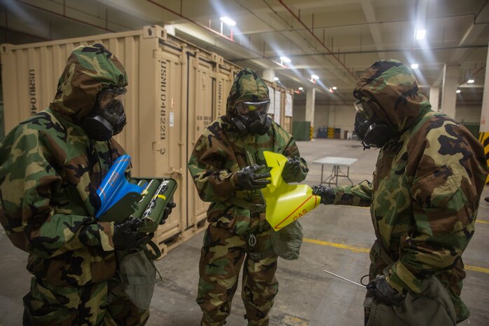 Marines place marked flags around a point of contamination during a reconnaissance, surveillance and decontamination (RSD) course conducted by chemical, biological, radiological and nuclear (CBRN) Marines with Combat Logistics Regiment 35, 3rd Marine Logistics Group July 17, 2018 at Camp Kinser, Okinawa, Japan. The RSD course ensures that Marines can effectively detect and decontaminate themselves in a CBRN environment and save lives of Marines in the area. (U.S. Marine Corps photo by Pfc. Terry Wong)