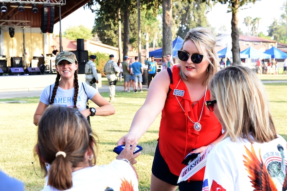 Incirlik Air Base USO members and U.S. Air Force volunteers hand out USO merchandise during the 4th of July celebration at Incirlik Air Base, Turkey, July 4, 2018.