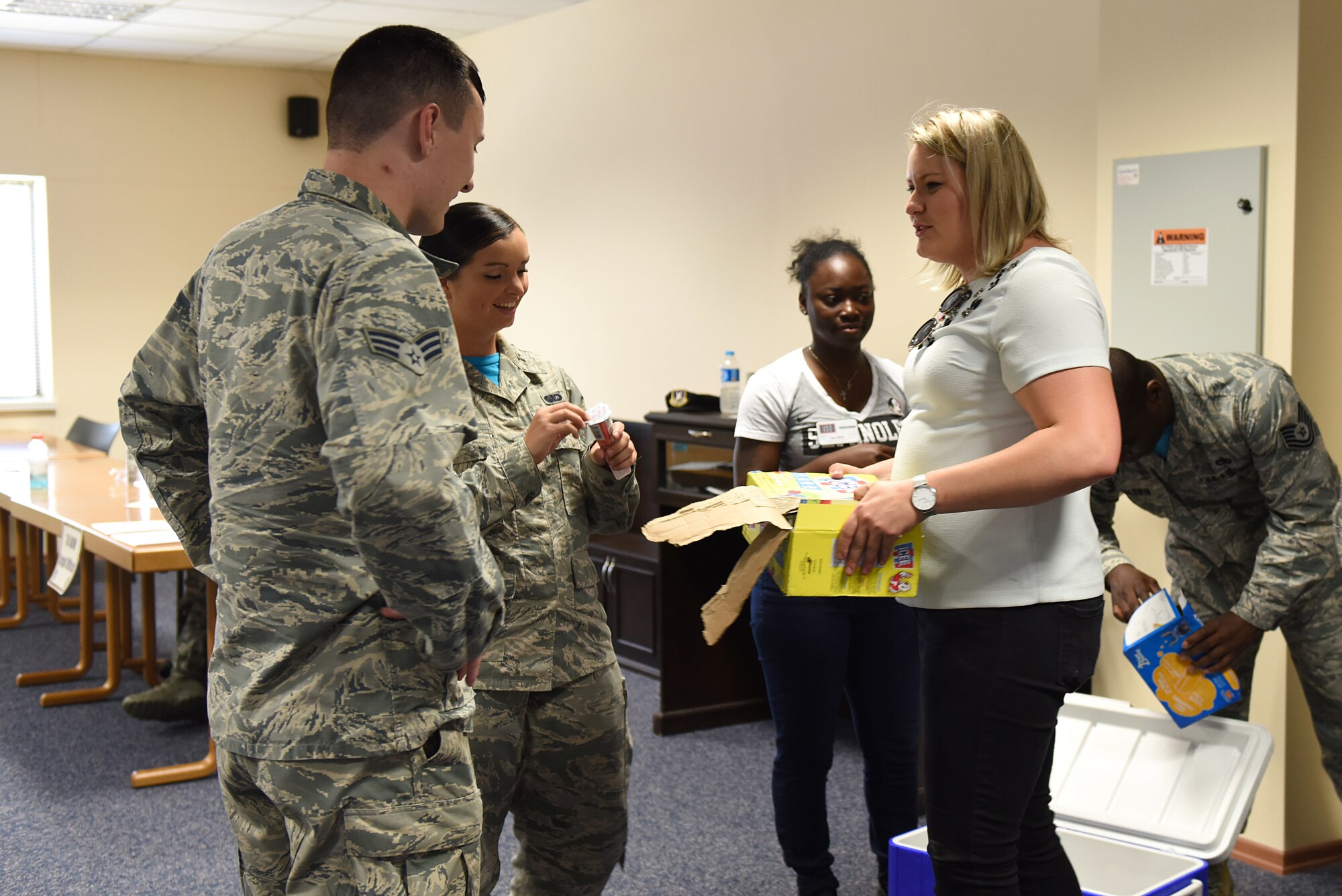 USO volunteer Lisa Wease and U.S. Air Force Airman 1st Class Valtrice Sullivan  hand out ice cream at Incirlik Air Base, Turkey, July 13, 2018.