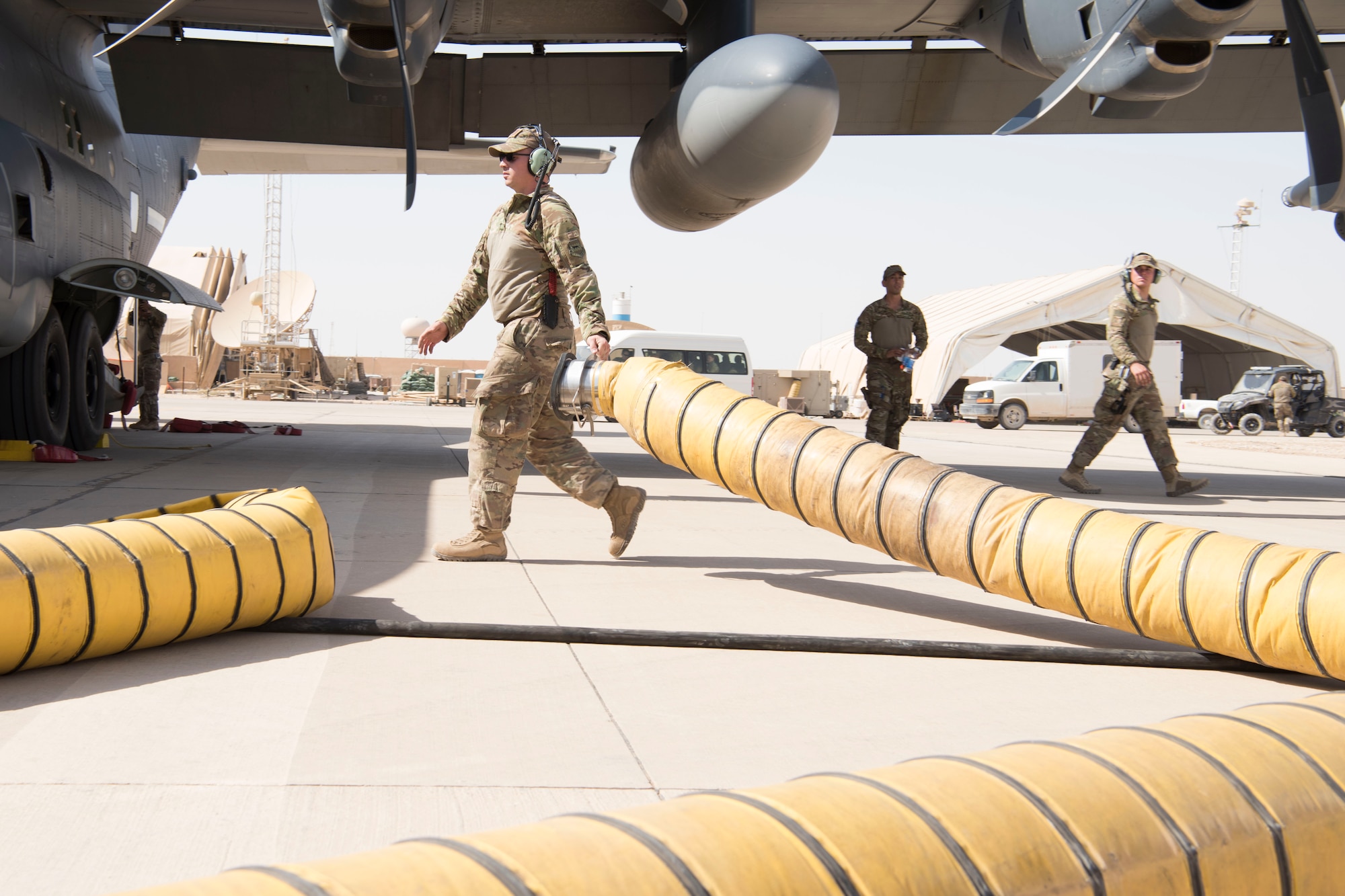 An Airman with the 801st Expeditionary Maintenance Squadron performs post-flight checks and maintenance on a C-130 Hercules, July 4, 2018, at Al Asad Air Base, Iraq.