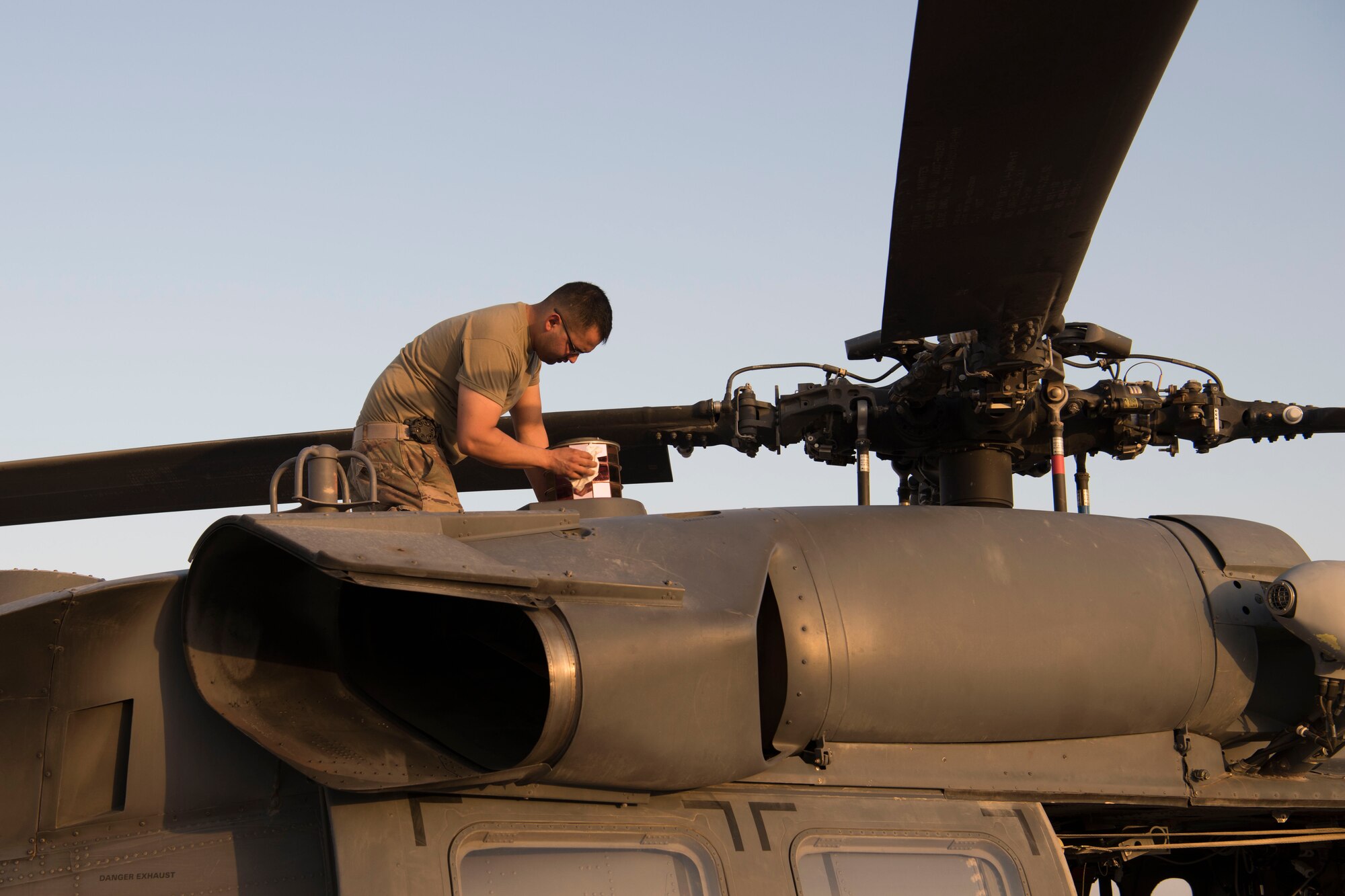 An Airman with the 1st Expeditionary Rescue Group prepares an HH-60 Pave Hawk for a nighttime flight, July 4, 2018, at Al Asad Air Base, Iraq.
