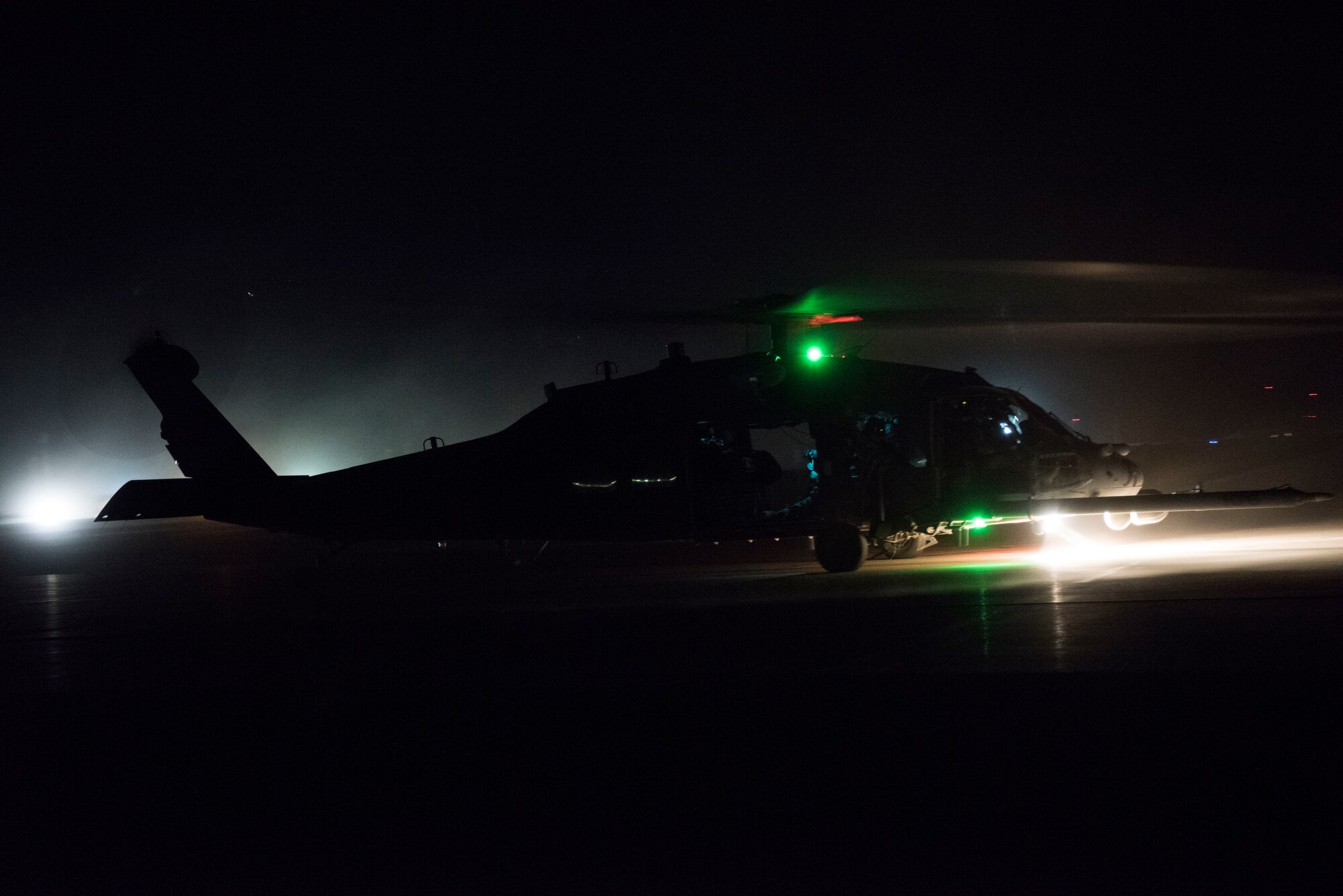 An HH-60 Pave Hawk takes off for a nighttime flight, July 4, 2018, at Al Asad Air Base, Iraq.