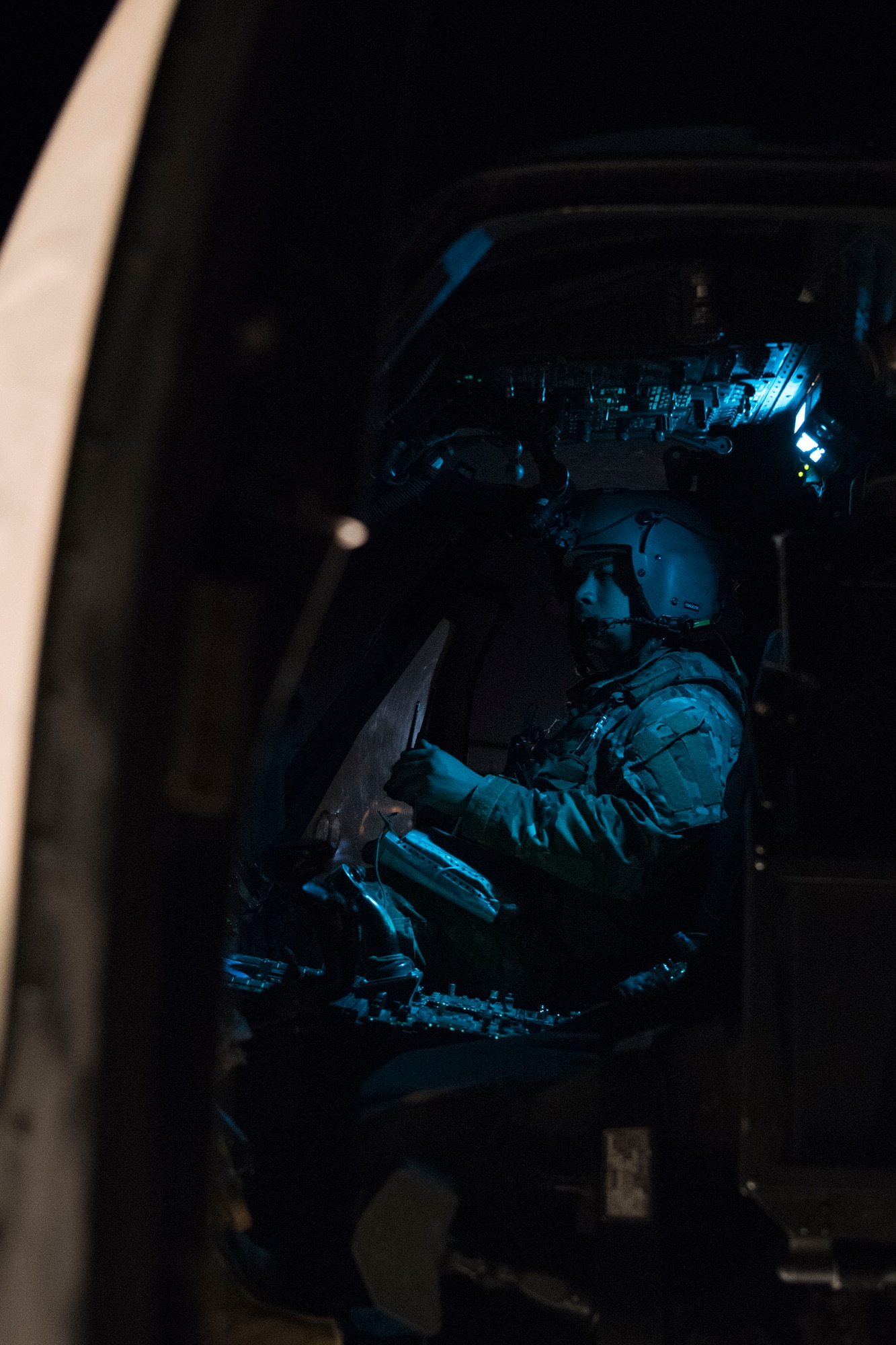 An HH-60 Pave Hawk pilot with the 1st Expeditionary Rescue Group performs post-flight checks, July 5, 2018, at Al Asad Air Base, Iraq.