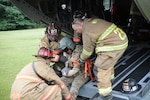 Civilian first responders from Dauphin and Schuylkill counties perform emergency care on a mock casualty of a simulated aviation disaster at Wiconisco, Pa., July 21, 2018.