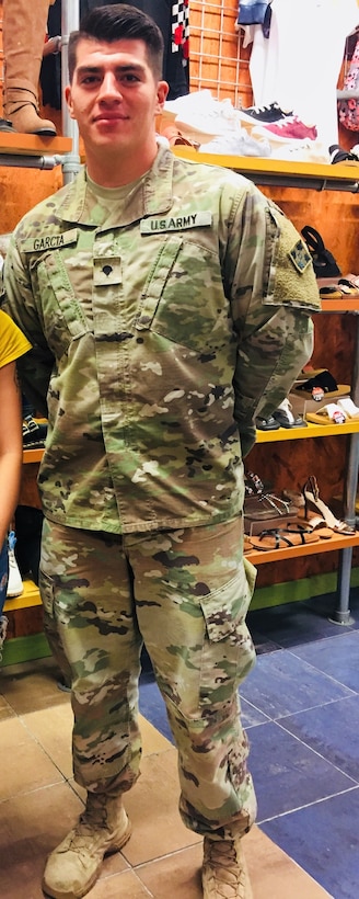 A soldier in camouflage stands in a store.
