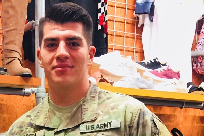 An Army specialist poses for a picture.