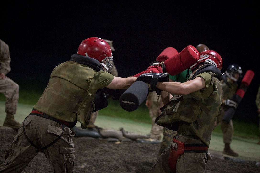 U.S. Marine Corps recruits of Echo Company, 2nd Battalion, Recruit Training Regiment, fight with pugil sticks during the Crucible July 20, 2018, on Parris Island, S.C. This training is part of the Marine Corps Martial Arts Program, which helps to create the warrior ethos by utilizing armed and unarmed techniques from various styles of martial arts. Echo Company is scheduled to graduate Aug. 3, 2018. Parris Island has been the site of Marine Corps recruit training since Nov. 1, 1915. Today, approximately 19,000 recruits come to Parris Island annually for the chance to become United States Marines by enduring 13 weeks of rigorous, transformative training. Parris Island is home to entry-level enlisted training for 49 percent of males and 100 percent for females in the Marine Corps.