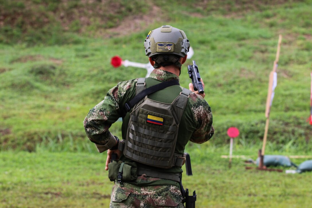 A shooter with team Colombia reloads his weapon to shoot his target
