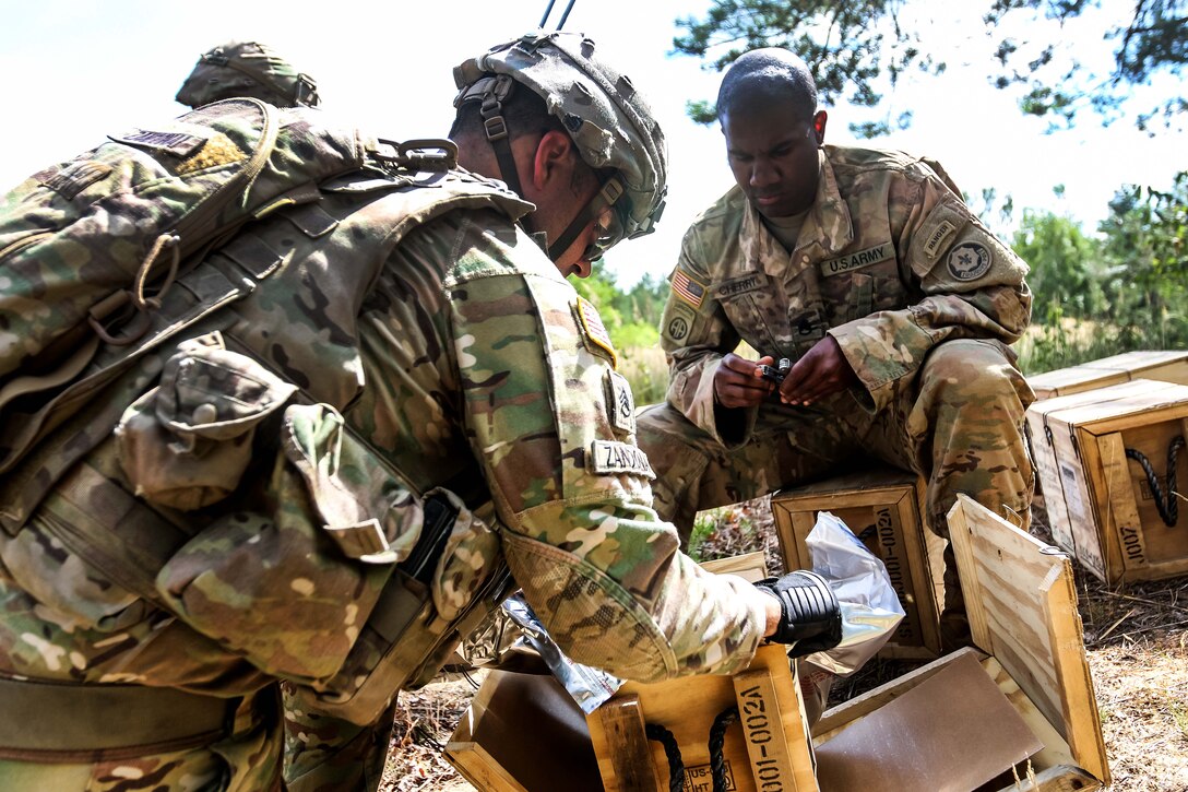 Soldiers unpack M18A1 claymore mines during a training exercise.