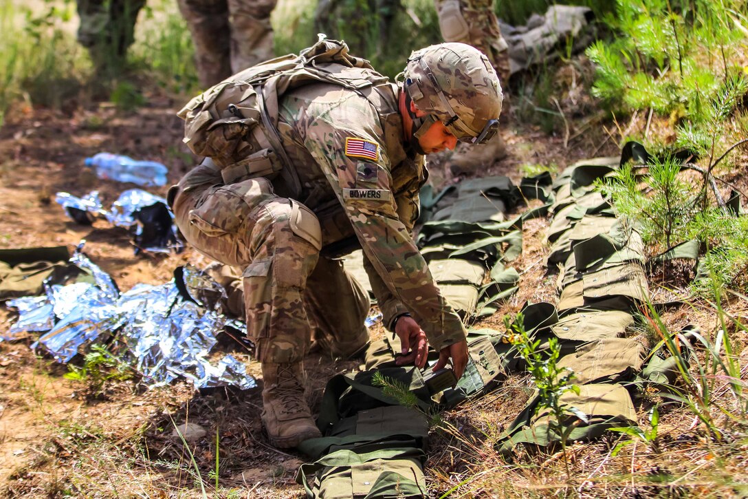 A soldier unpacks and prepares M18A1 claymore mines during a training exercise.