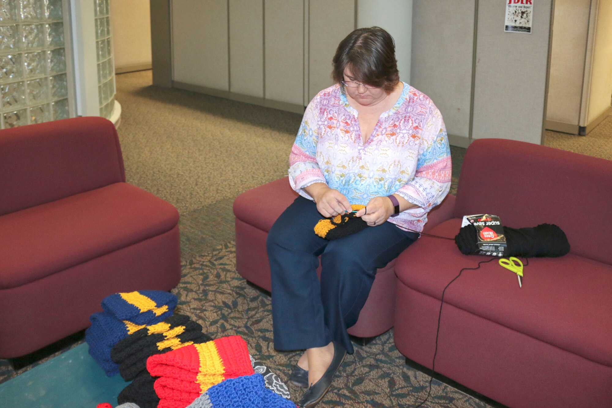 AEDC team member Tracy Carter crochets during a break from her duties as management and program assistant for the Test Systems Sustainment Division at Arnold Air Force Base. Carter is leading a service project crocheting beanies for veterans at the Alvin C. York Campus of the VA Tennessee Valley Healthcare System in Murfreesboro. She invites others who enjoy crocheting or knitting to help her in this service project. If interested in crocheting or assisting the project in another way, call 931-454-7253. (U.S. Air Force photo/Deidre Ortiz)