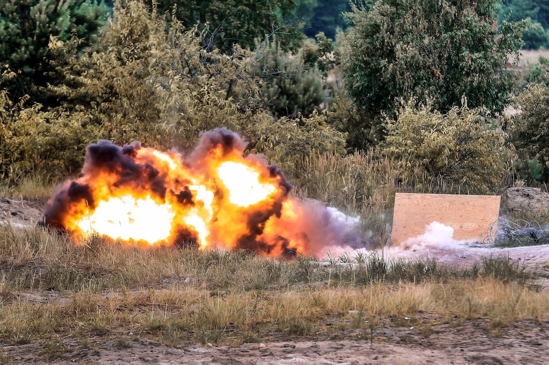 U.S. and British army soldiers detonate an M18A1 Claymore mine.