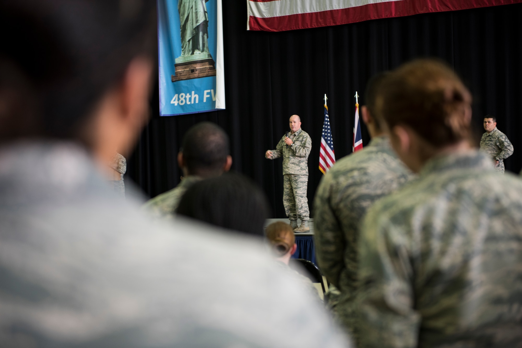 U.S. Air Force Col. William Marshall, 48th Fighter Wing commander, speaks to Liberty Wing Airmen during an All Call at Royal Air Force Lakenheath, England, July 20, 2018. Marshall explained his top priorities and vision for the wing including readiness, preparing for the future, and developing and retaining Airmen. (U.S. Air Force photo/ Senior Airman Malcolm Mayfield)