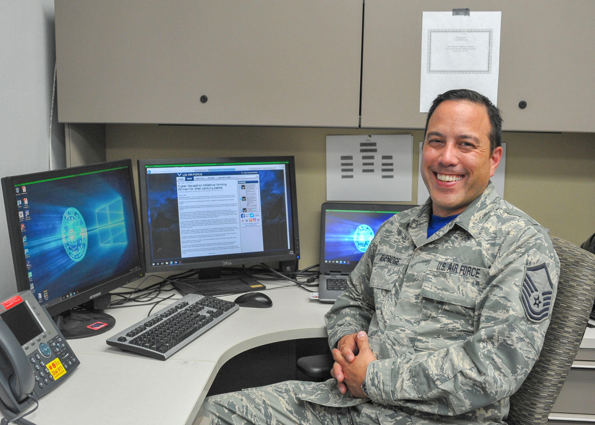 Master Sgt. Robert Beveridge, non-commissioned officer in charge of the 910th Communications Squadron’s cyber systems operations section, poses for a photo at his workstation here, July 14.