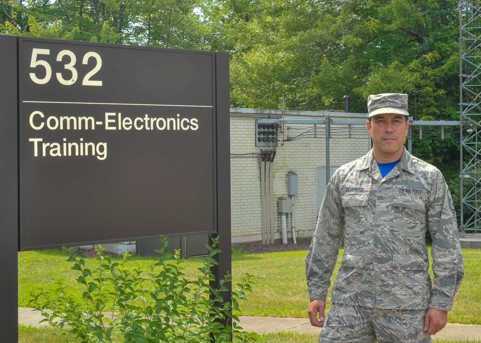 Master Sgt. Robert Beveridge, non-commissioned officer in charge of the 910th Communications Squadron’s cyber systems operations section, poses for a photo in front of his work center here, July 14.