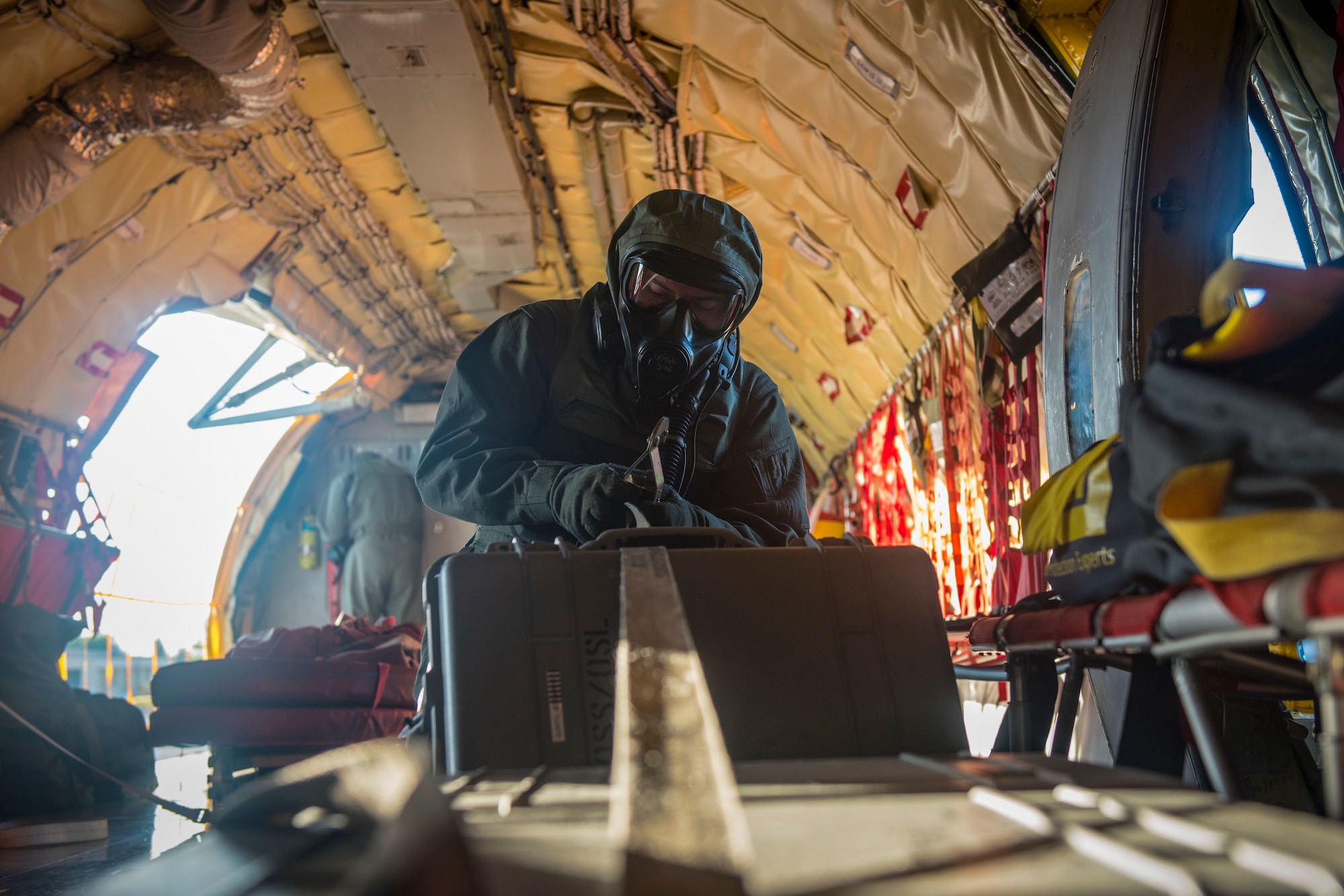 Senior Airman Stetson Vigil, 93rd Air Refueling Squadron boom operator, secures cargo during the first in-field use and test of the new Joint Service Aircrew Mask on a KC-135 Stratotanker at Fairchild Air Force Base, Washington, July 17, 2018. The gear enhances the ability to operate because of the reduced footprint of the gear while still allowing maximum protection. (U.S. Air Force photo/ Airman 1st Class Whitney Laine)