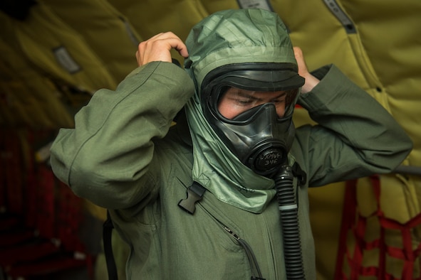 Senior Airman Stetson Vigil, 93rd Air Refueling Squadron boom operator, dons a new Joint Service Aircrew Mask at Fairchild Air Force Base, Washington, July 17, 2018, during the first KC-135 Stratotanker in-field use and test. The JSAM is a new chemical and biological defense mask/hood combination designed to replace former six-decades-old aircrew masks in the Department of Defense inventory. (U.S. Air Force photo/ Airman 1st Class Whitney Laine)