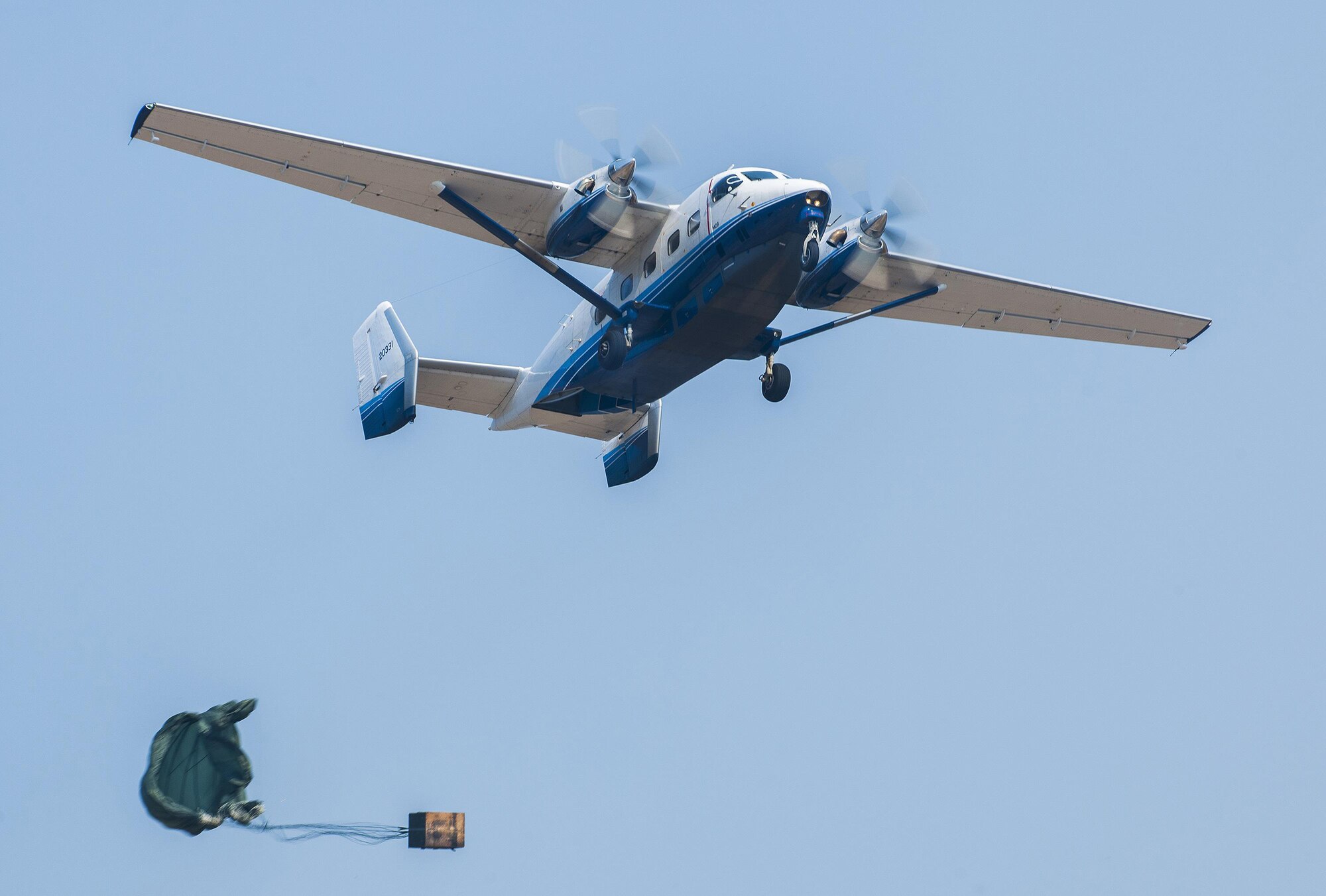 A parachuted bundle soars from a C-145 Skytruck during an airdrop mission near Duke Field, Fla.. New and prior-qualified loadmasters release sandbags and 300-pound boxes from the 919th Special Operations Wing aircraft as part of their initial airdrop or proficiency training.