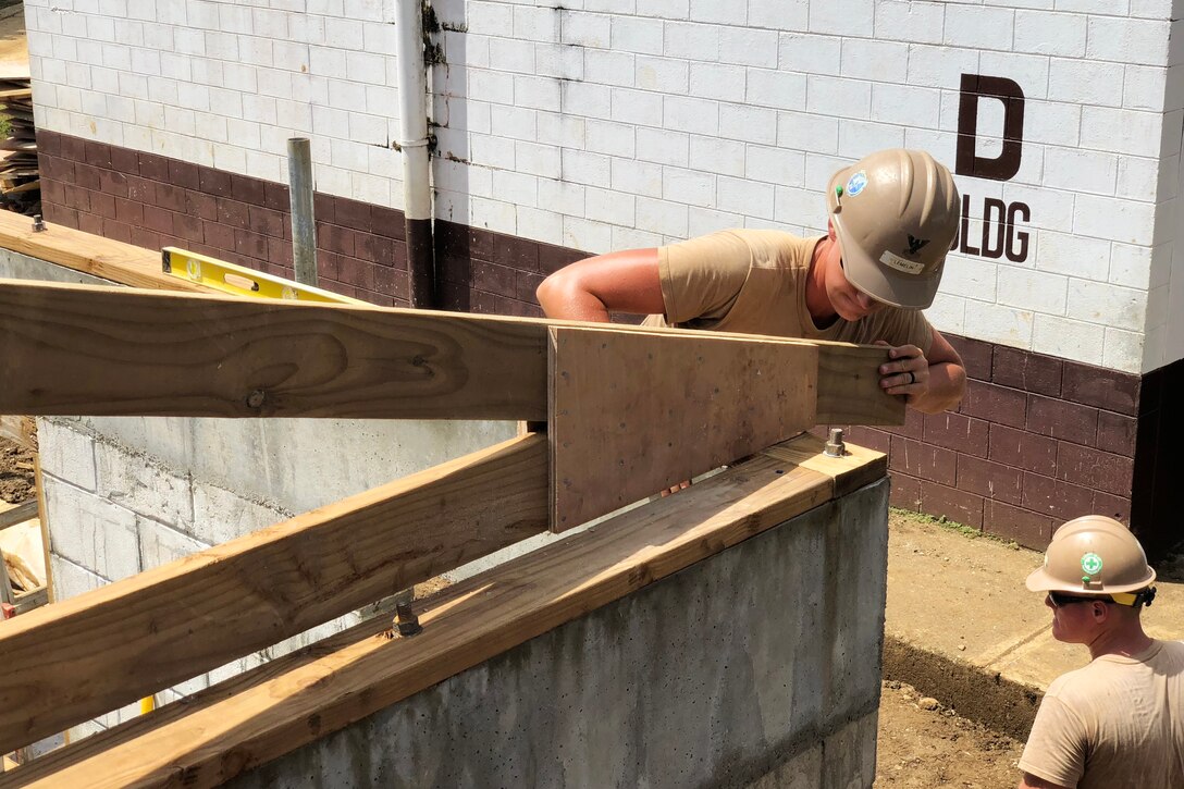 Navy sailors continue working on classrooms.