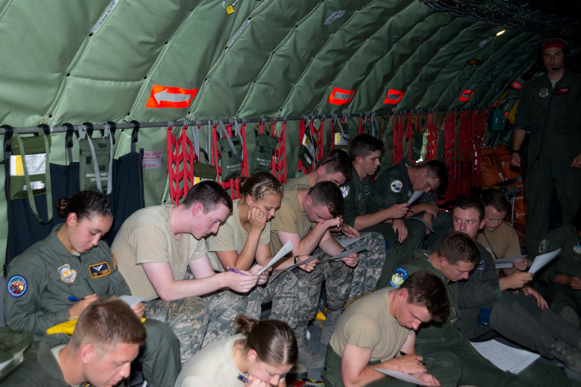 U.S. Air Force Academy and Reserve Officer Training Corps cadets study a group activity worksheet on a KC-135 Stratotanker aircraft assigned to MacDill Air Force Base, Fla., July 2, 2018.