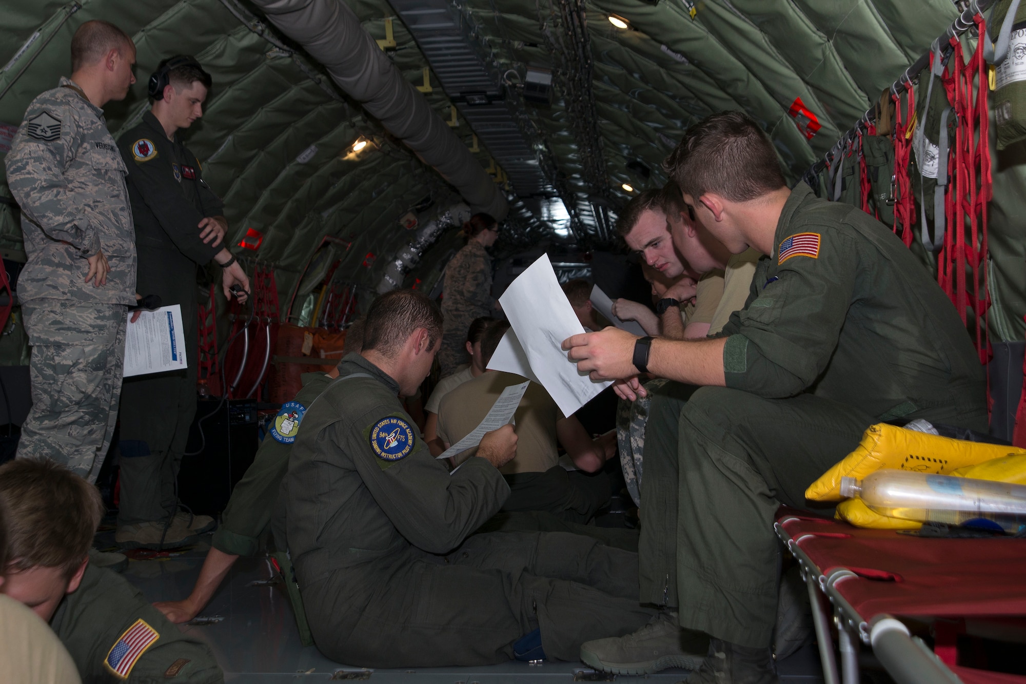 U.S. Air Force Academy and Reserve Officer Training Corps cadets study a group activity worksheet on a KC-135 Stratotanker aircraft assigned to MacDill Air Force Base, Fla., July 2, 2018.