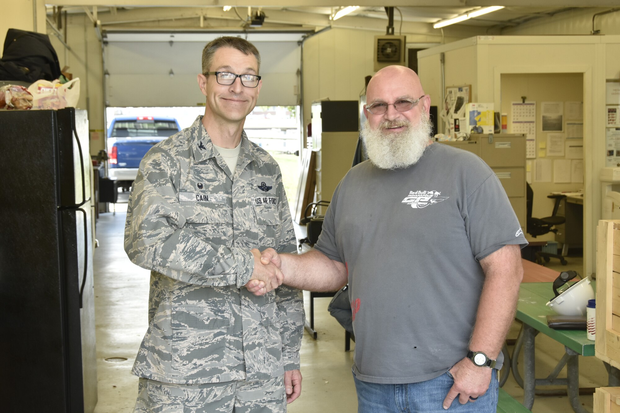 Paul Buckner, right, is recognized by AEDC Commander Col. Scott Cain. Buckner, a machinist at Arnold Air Force Base, was recognized for calling for an Aerodynamic and Propulsion Test Unit pump to be shut down after observing an abnormal sound from the pump, a move that is credited with preventing catastrophic failure.