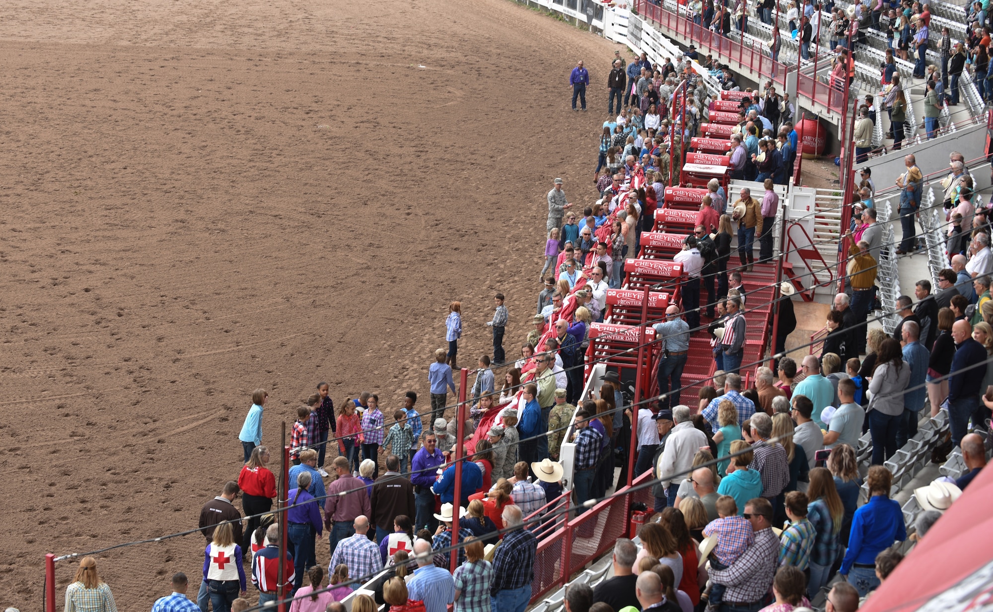 Members of the military and community carry the American Flag during Military Monday at Frontier Park in Cheyenne, Wyo., July 23, 2018. Leadership from local military installations including F.E. Warren Air Force Base were invited to be a part of the Military Monday festivities. The Airmen’s involvement during CFD provides an opportunity to showcase the strong relationship between the base and the local community. (U.S. Air Force photo by Airman 1st Class Abbigayle Wagner)