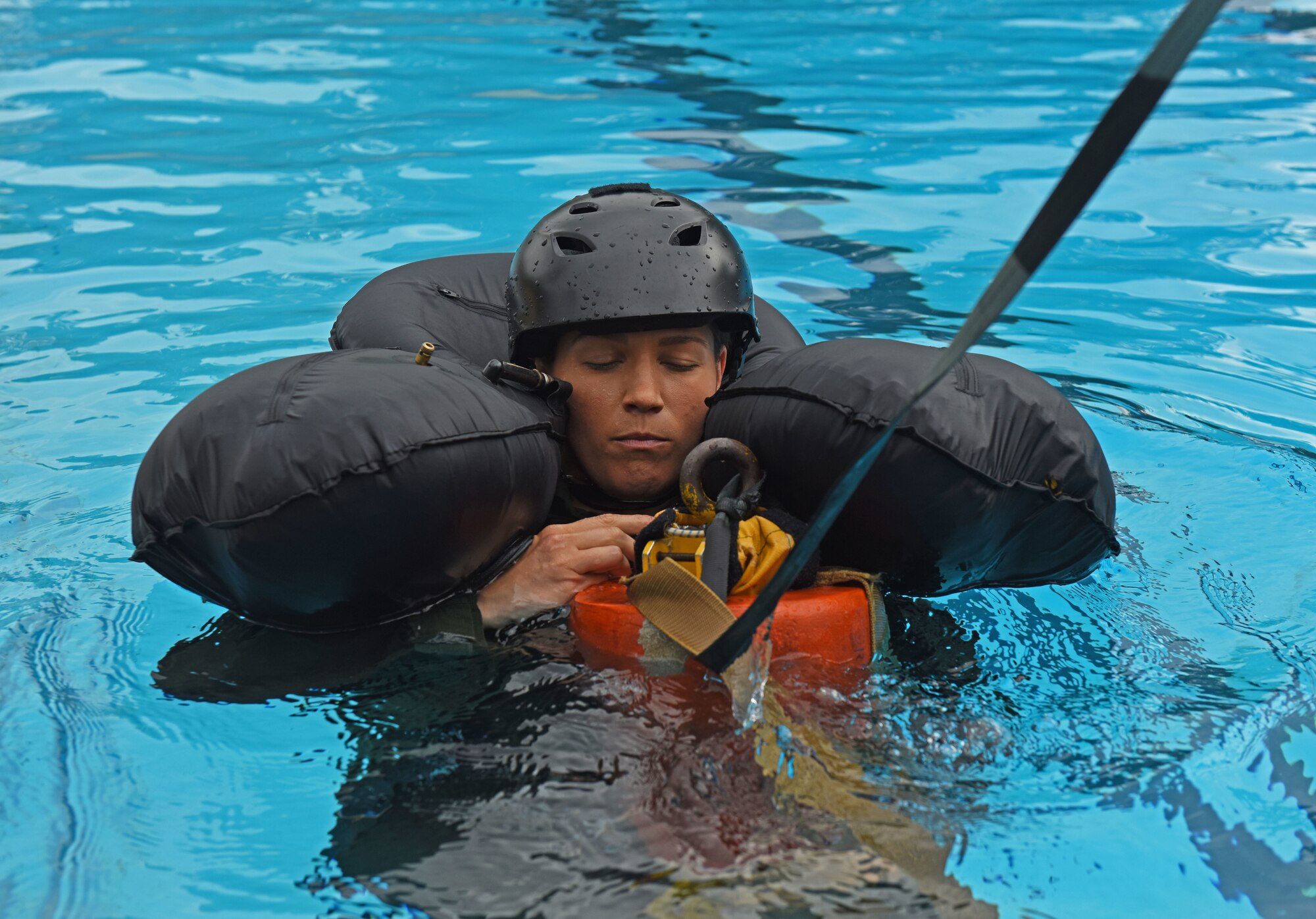U.S. Air Force Capt. Zoe Kotnik, 55th Fighter Squadron chief of training, simulates being pulled out of water by a rescue helicopter at Shaw Air Force Base, S.C., July 19, 2018.