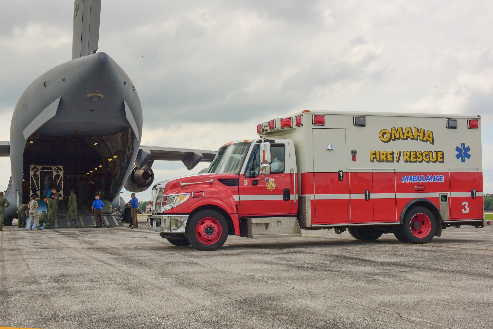 Airmen from the 628th and 375th Aeromedical Evacuation Squadrons prepare to transfer simulated patients from a Transportation Isolation System on a C-17 Globemaster III to an ambulance during an exercise July 18, 2018 at Offut Air Force Base, Neb. The TIS is an enclosure the Department of Defense can use to safely transport patients with highly contagious diseases.