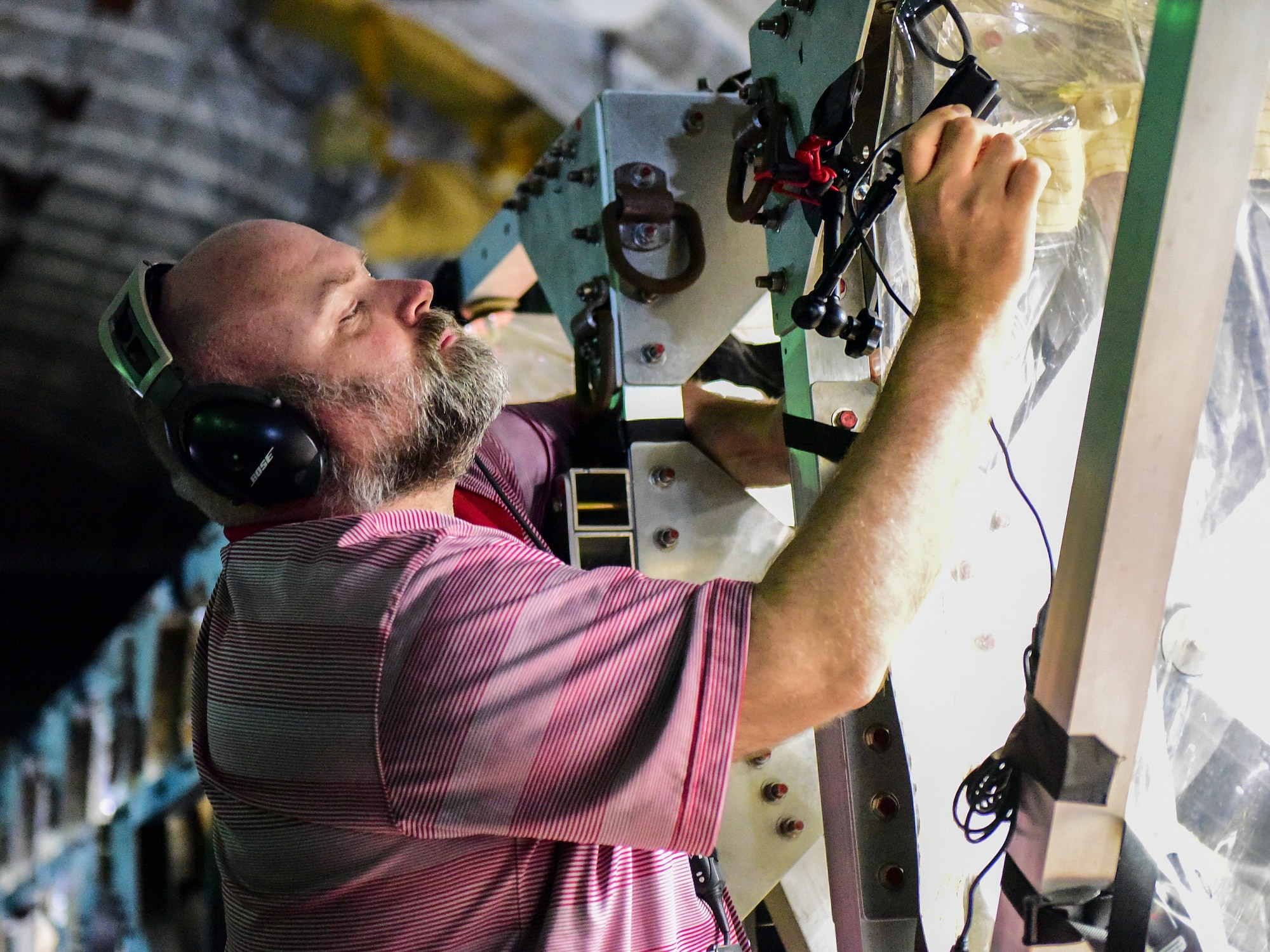 Shawn G. Gibbs, Indiana School of Public Health professor, mounts a camera to a transportation isolation system to capture footage for later analysis during an exercise July 18, 2018, at Joint Base Charleston, S.C.  Aeromedical Airmen and medical researchers from Indiana and Nebraska universities conducted TIS training to evaluate the procedures for transportation of highly infectious patients from one location to another via aeromedical evacuation.