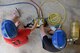 Junior firefighters, Evelynn Neddo and Nate Henry, control an air pressure switch during the Junior Firefighter Camp at the Fire Station on Goodfellow Air Force Base, Texas, July 17, 2018. The switch operates airbags that firefighters use to lift cars during an accident. (U.S. Air Force photo by Staff Sgt. Joshua Edwards/Released)