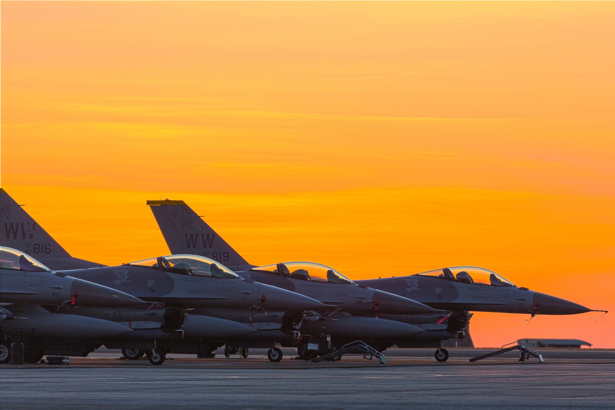 A line up of U.S. Air Force F-16Cs, assigned to the 14th Fighter Squadron, Misawa Air Base, Japan, sit on the tarmac at Royal Australian Air Force (RAAF) Base Darwin during Exercise Pitch Black 16, August 4, 2016. Pitch Black is a biennial multinational air warfare exercise hosted by the RAAF that focuses on offensive counter air and defensive counter air combat in a simulated war environment.