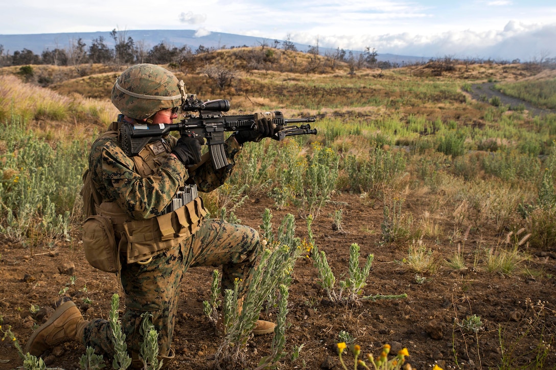 A Marine takes aim while providing security during a live-fire training event.