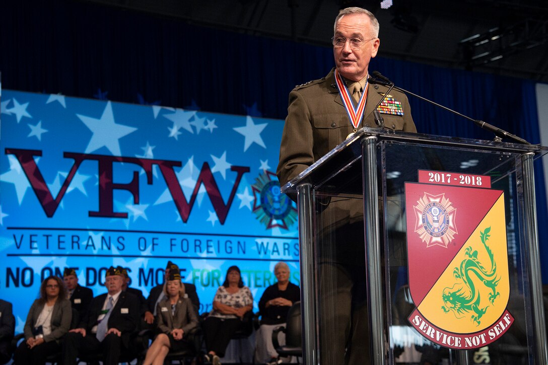 Marine Corps Gen. Joe Dunford, chairman of the Joint Chiefs of Staff, addresses a crowd from a podium.
