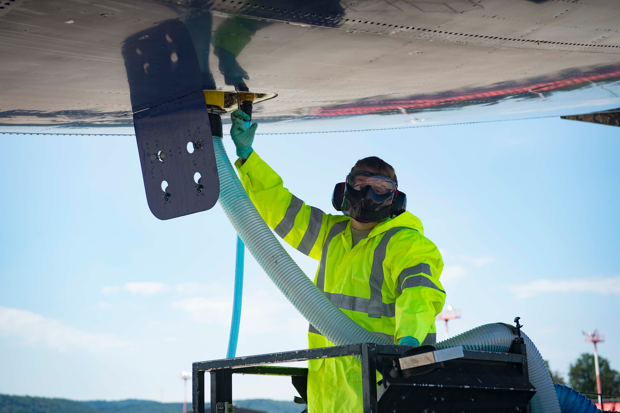 U.S. Air Force Senior Airman Mark Bandeko Jr., 721st Aerial Port Squadron Fleet Services specialist, drains a Boeing 747 aircraft lavatory tank on Ramstein Air Base, Germany, July 18, 2018. Fleet services provides ground servicing, such as lavatory flushing, and delivering meals, igloos, pillows, blankets, and potable water for passenger comfort. (U.S. Air Force photo by Senior Airman Elizabeth Baker)