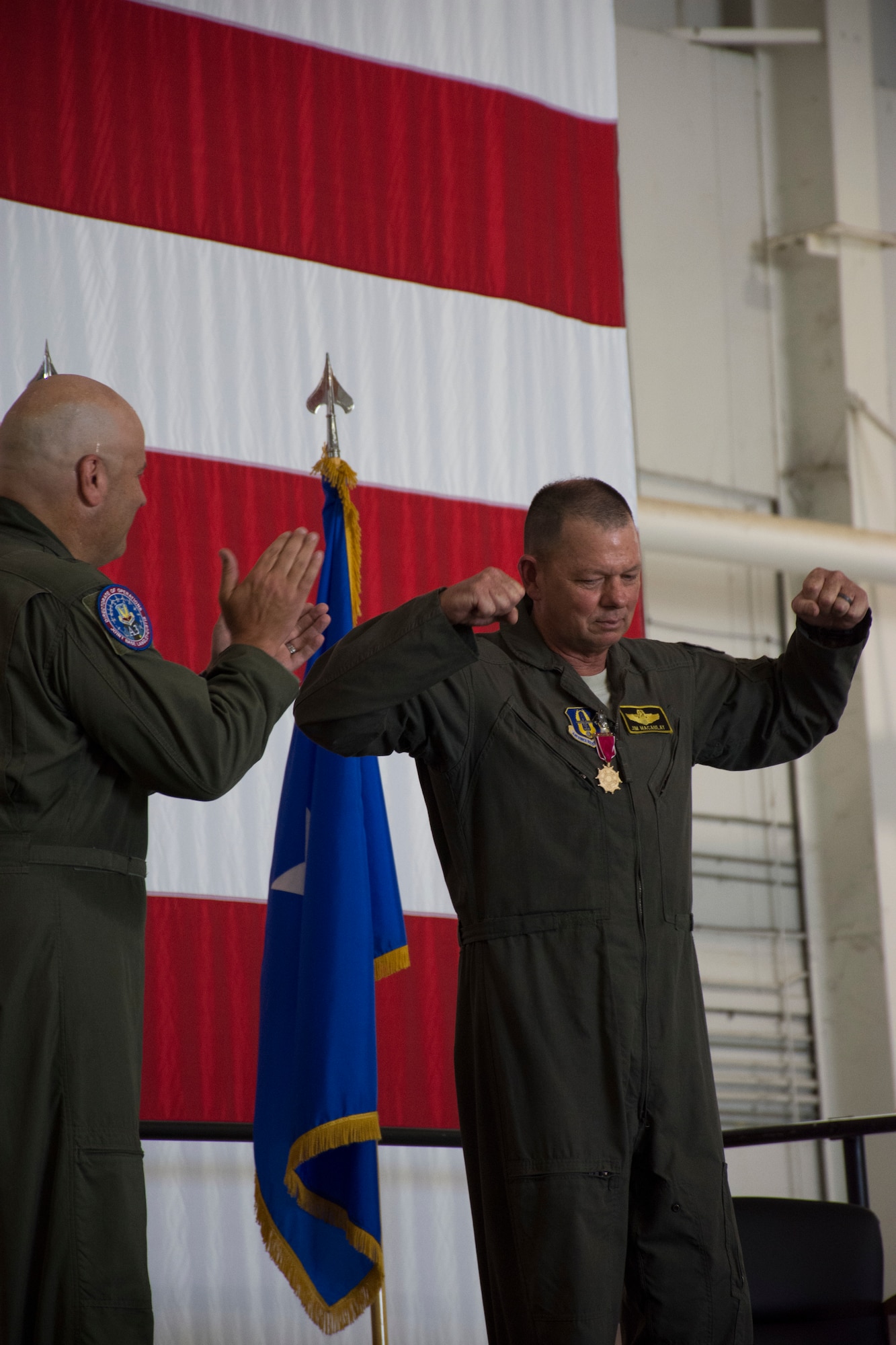 Brig. Gen. Brian K. Borgen claps as Col. Jim Macaulay makes a celebratory gesture.