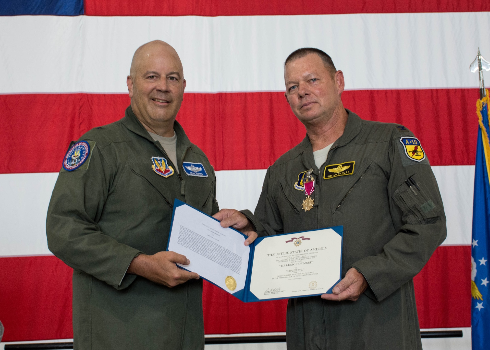 Brig. Gen. Brian K. Borgen presents Col. Jim Macaulay a retirement certificate.