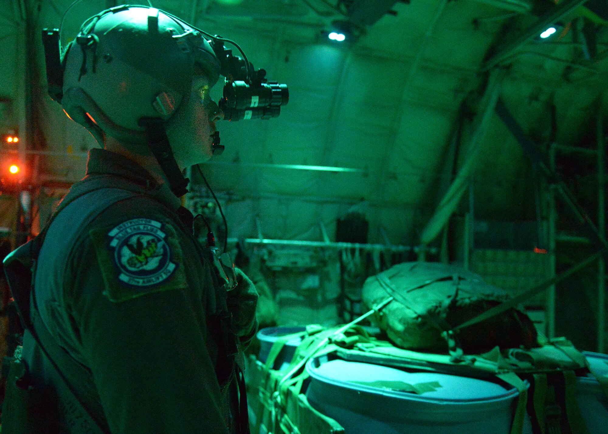 A U.S. Air Force loadmaster uses night vision goggles during a night flight over Bulgaria, July 15, 2018. During Thracian Summer 18, deployed members accomplished 2,173 training events, of which 347 were night and night vision goggle specific events. (U.S. Air Force photo by Staff Sgt. Jimmie D. Pike)