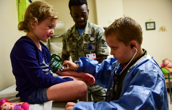 Caleb Pettit, 9, checks a patient’s heartbeat while playing doctor, July 20, 2018, at Joint Base Charleston, S.C.