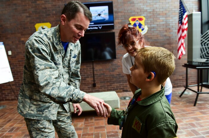 Caleb Pettit, 9, receives a commander’s coin from Col. Jeffrey Nelson, 628th Air Base Wing commander, July 20, 2018, at Joint Base Charleston, S.C.