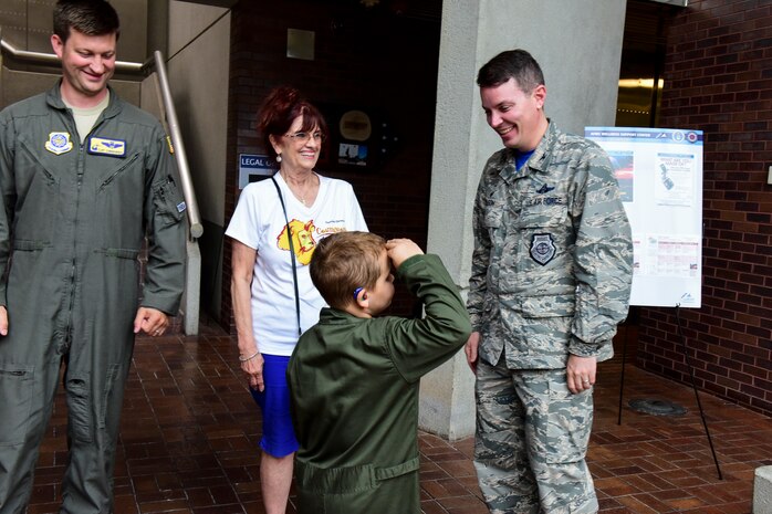 Caleb Pettit, 9, salutes Col. Jeffrey Nelson, 628th Air Base Wing commander after receiving a commander’s coin, July 20, 2018, at Joint Base Charleston, S.C.