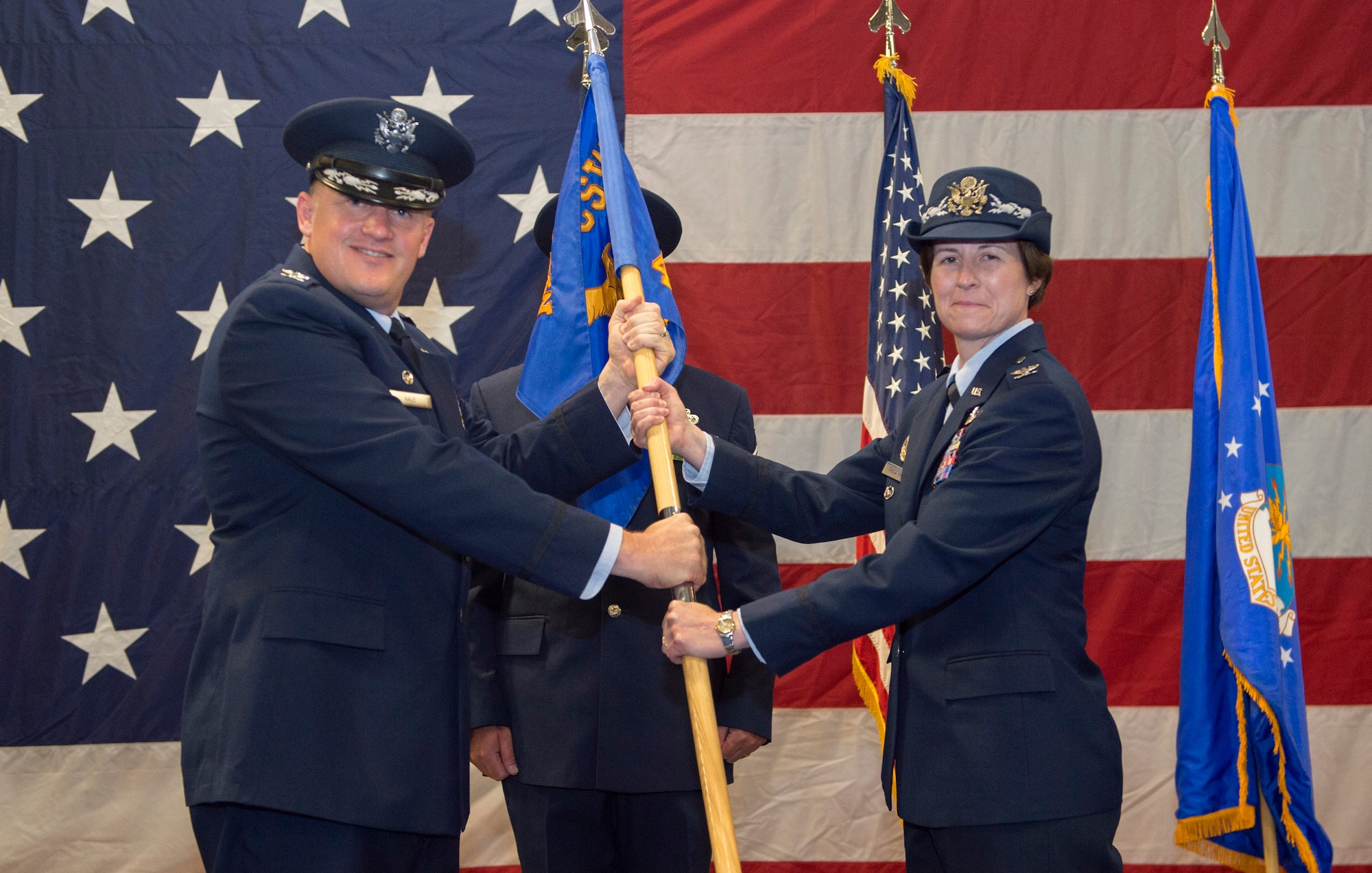 U.S. Air Force Col. Bridget Mcnamara, 422nd Air Base Group commander, accepts the group gude-on from Col. William Kale, 501st Combat Support Wing commander, at RAF Croughton, United Kingdom, July 20, 2018. (U.S. Air Force photo by Senior Airman Chase Sousa)