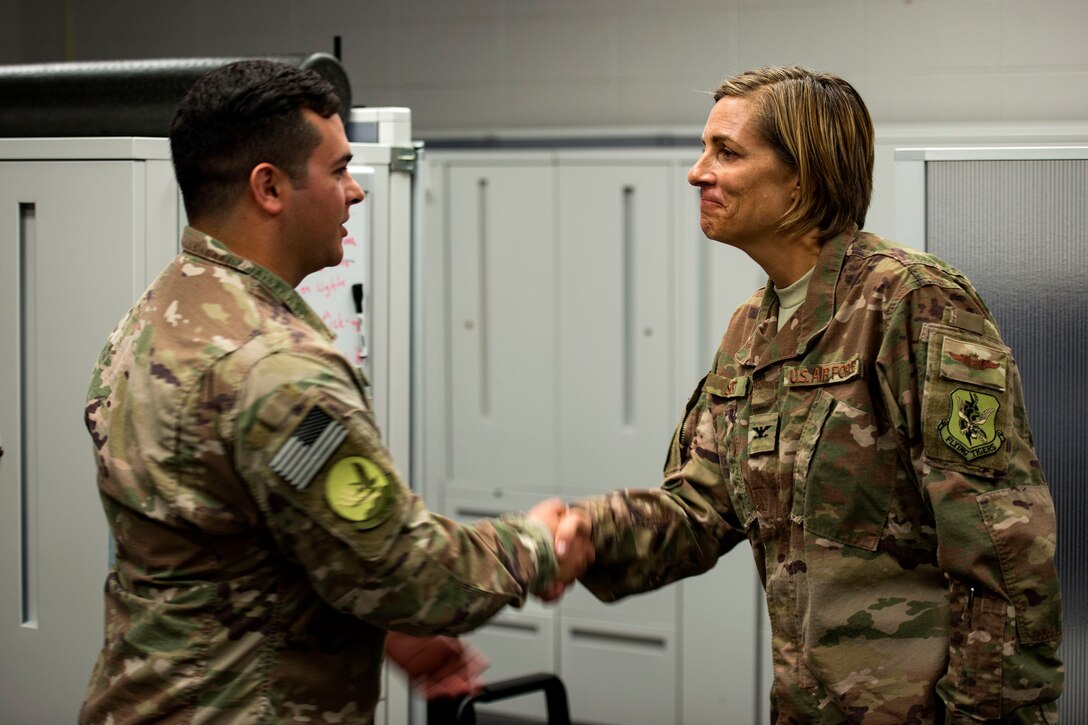 Col. Jennifer Short, right, 23d Wing commander, coins Staff Sgt. Michael Triana, 347th Operations Support Squadron (OSS) independent duty medical technician (IDMT) paramedic, during an immersion tour, July 23, 2018, at Moody Air Force Base, Ga. During the immersion, Short visited with Survival, Evasion, Resistance, Escape (SERE) and medical specialists from the 347th OSS. The 347th OSS rescue training center houses both IDMT paramedics and SERE specialists, whose mission is to train and equip Airmen to be able to survive and save lives while in austere environments. (U.S. Air Force photo by Airman 1st Class Erick Requadt)